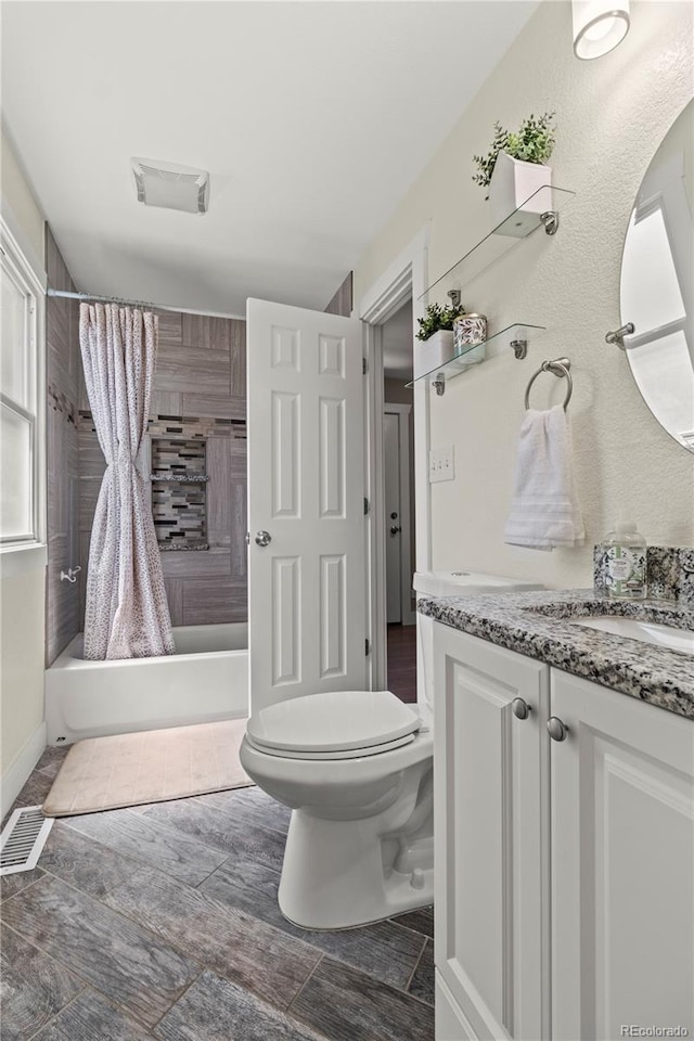 full bathroom with shower / bathtub combination with curtain, vanity, and toilet