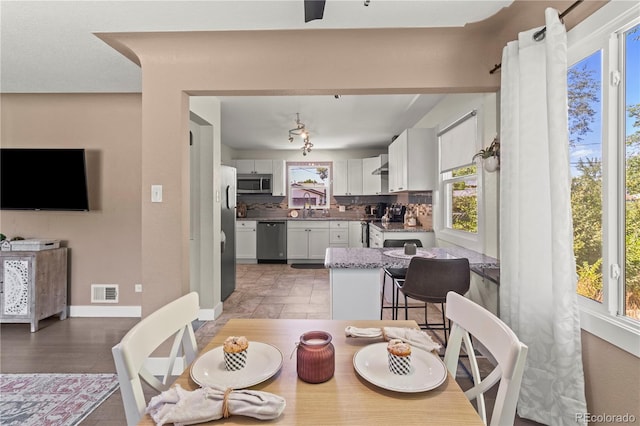 dining area featuring wood-type flooring and sink