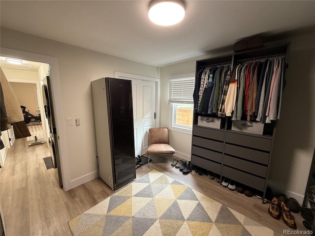 1694 Xanthia St, Denver, CO 80220 - bedroom with light wood-type flooring, freestanding refrigerator, and baseboards