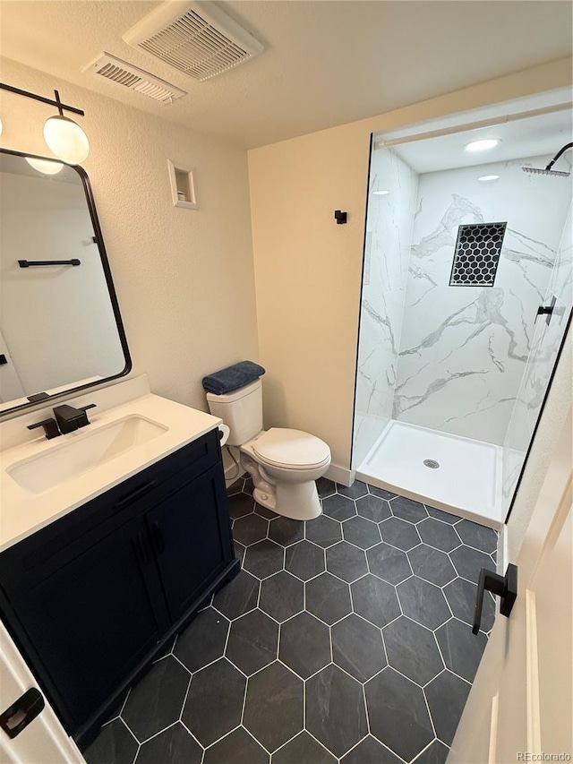 1694 Xanthia St, Denver, CO 80220 - full bath with vanity, toilet, a marble finish shower, and tile patterned floors