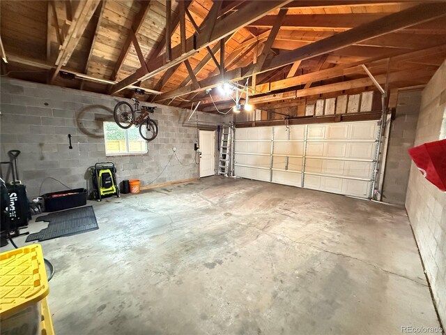 1694 Xanthia St, Denver, CO 80220 - garage with concrete block wall and a garage door opener