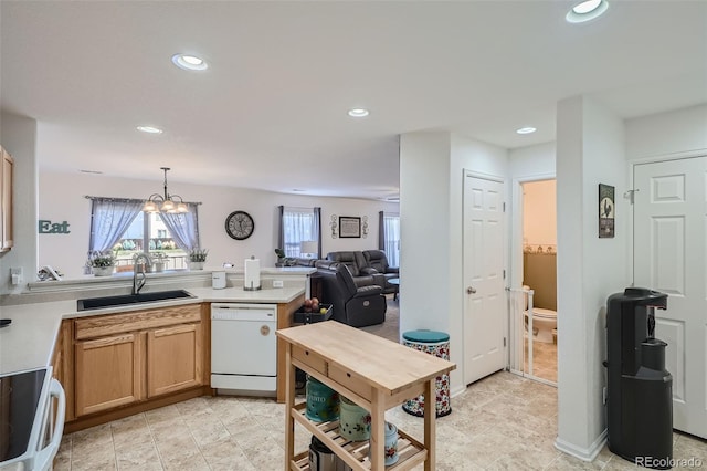 kitchen with pendant lighting, dishwasher, an inviting chandelier, sink, and stove