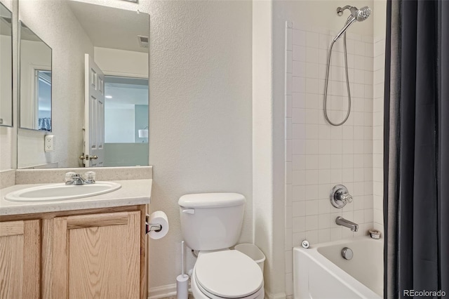 full bathroom featuring vanity, toilet, and tiled shower / bath