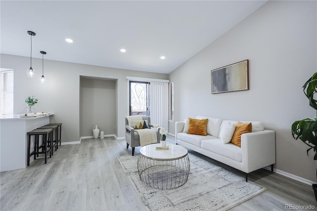 living area with recessed lighting, lofted ceiling, baseboards, and wood finished floors