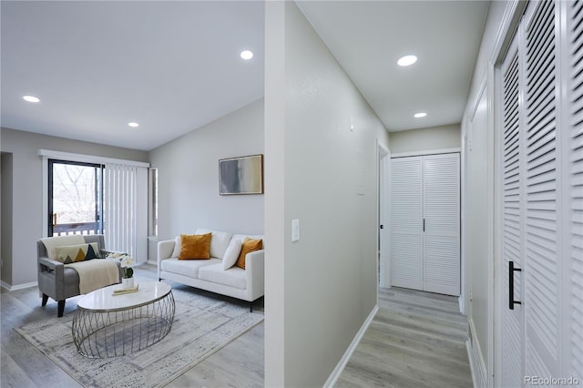 hall featuring recessed lighting, baseboards, and wood finished floors