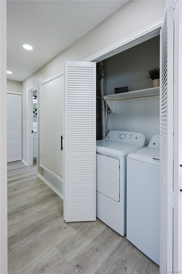 washroom featuring washer and dryer, laundry area, recessed lighting, and light wood-style floors