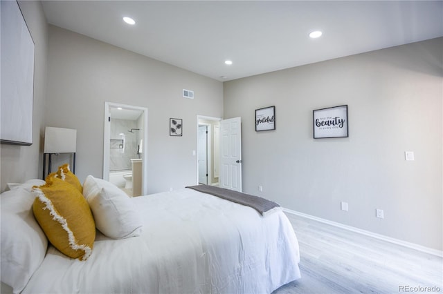 bedroom featuring wood finished floors, visible vents, baseboards, ensuite bath, and recessed lighting