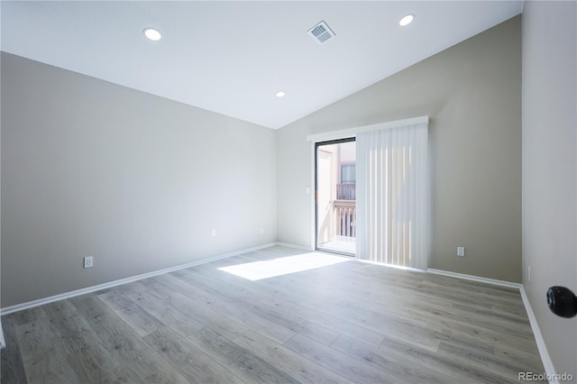 empty room with wood finished floors, visible vents, baseboards, recessed lighting, and vaulted ceiling