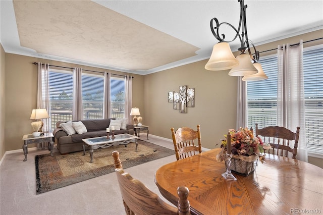 carpeted dining room featuring crown molding and a healthy amount of sunlight