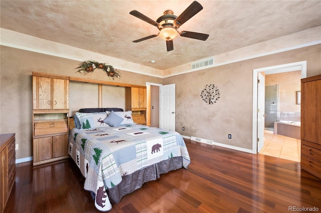 bedroom with hardwood / wood-style flooring, ensuite bath, and ceiling fan