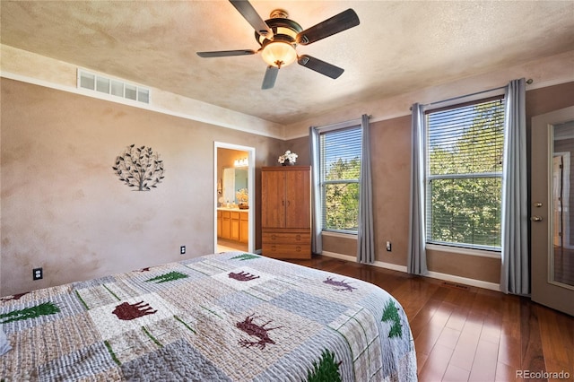 bedroom featuring ceiling fan, dark wood-type flooring, and a textured ceiling