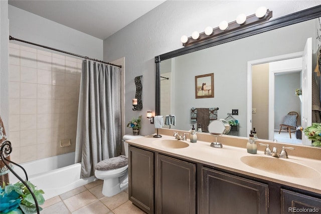 full bathroom featuring vanity, shower / bathtub combination with curtain, tile patterned floors, and toilet