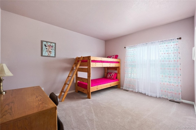 carpeted bedroom featuring a textured ceiling