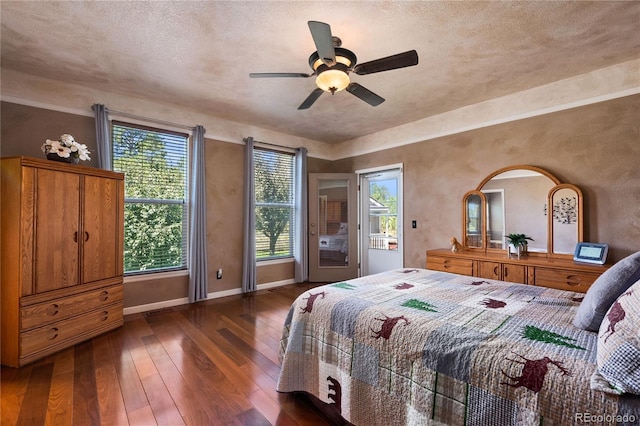 bedroom with dark hardwood / wood-style floors, a textured ceiling, access to exterior, and ceiling fan