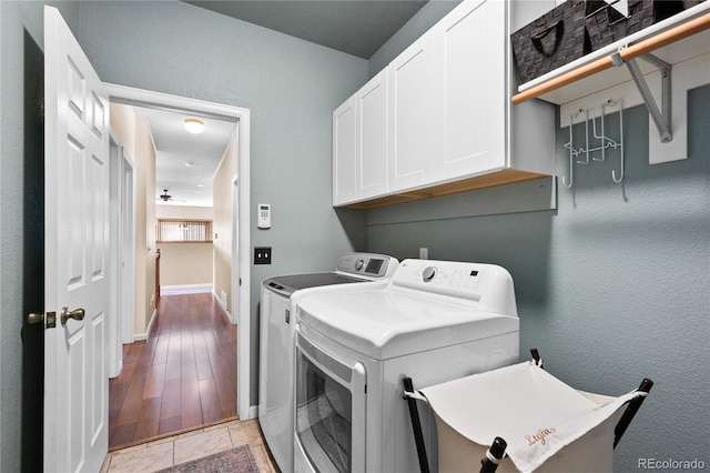 laundry area featuring cabinets and washing machine and clothes dryer