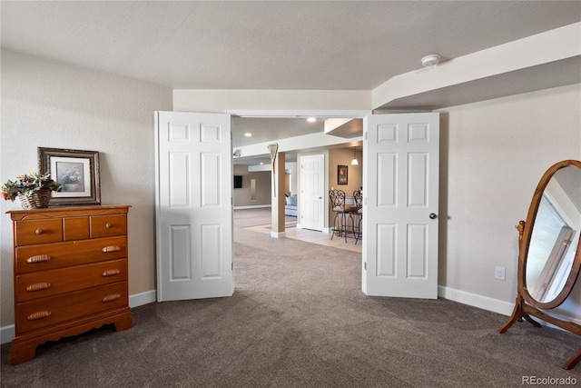 interior space featuring carpet flooring and a textured ceiling