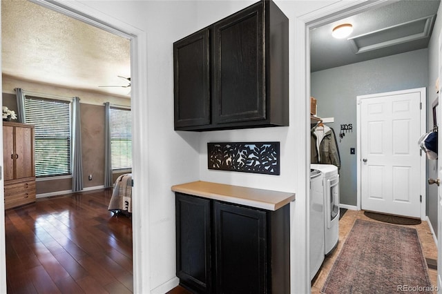 washroom with ceiling fan, washer and clothes dryer, dark hardwood / wood-style floors, and a textured ceiling