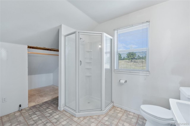 bathroom with a shower with shower door and toilet