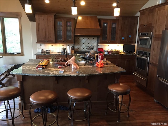 59 Club House Road 1/2Quarter Share D, Breckenridge, CO 80424 - kitchen with appliances with stainless steel finishes, custom exhaust hood, dark wood finished floors, a warming drawer, and a center island