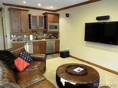 59 Club House Road 1/2Quarter Share D, Breckenridge, CO 80424 - kitchen featuring appliances with stainless steel finishes, decorative backsplash, glass insert cabinets, recessed lighting, and light countertops
