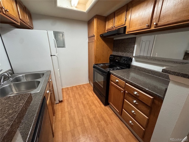 kitchen with tasteful backsplash, sink, light hardwood / wood-style flooring, and black appliances