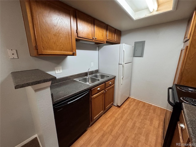 kitchen with electric panel, sink, light hardwood / wood-style flooring, and black appliances