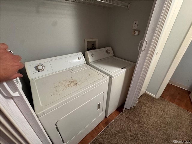 clothes washing area with carpet and washer and dryer