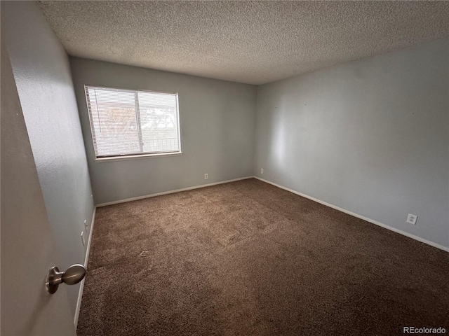 carpeted spare room featuring a textured ceiling