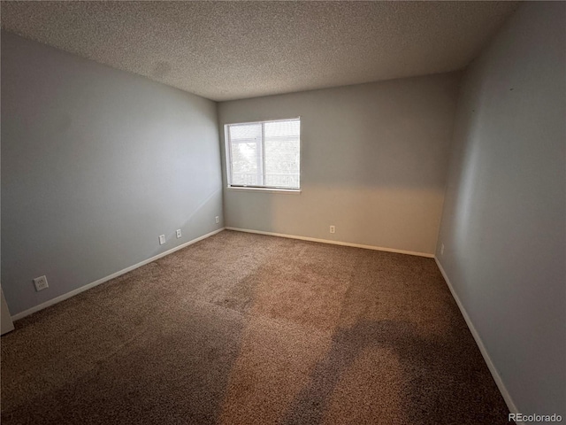 carpeted empty room with a textured ceiling