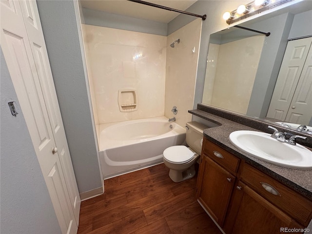 full bathroom with shower / bath combination, vanity, hardwood / wood-style floors, and toilet