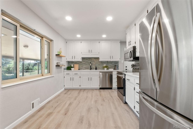 2963 S Vrain St, Denver, CO 80236 - kitchen with stainless steel appliances, light countertops, white cabinetry, and recessed lighting