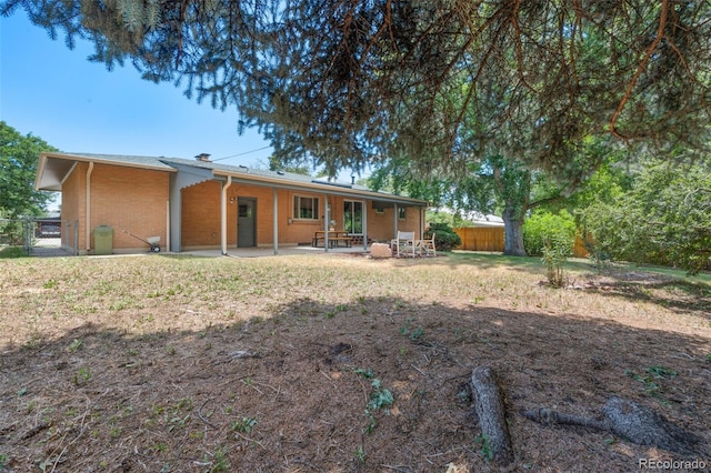 2963 S Vrain St, Denver, CO 80236 - back of house with a patio and brick siding