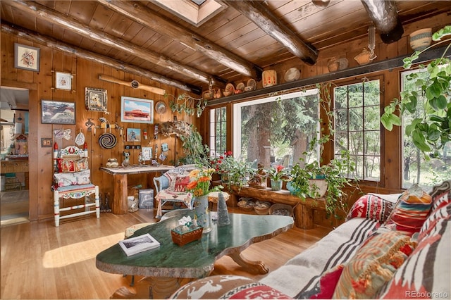 5975 Wellington Rd, Cascade, CO 80809 - living room with a wood ceiling with exposed beams, wooden walls, and wood finished floors