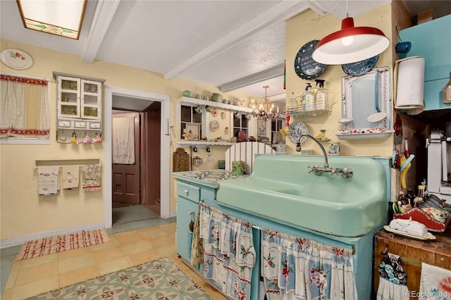 5975 Wellington Rd, Cascade, CO 80809 - kitchen with beam ceiling, a chandelier, and tile patterned floors