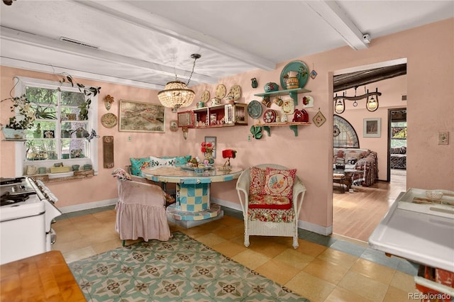 5975 Wellington Rd, Cascade, CO 80809 - dining room with beam ceiling, breakfast area, and a chandelier