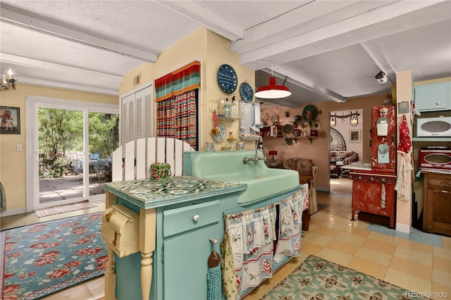 5975 Wellington Rd, Cascade, CO 80809 - kitchen featuring beam ceiling and green cabinets