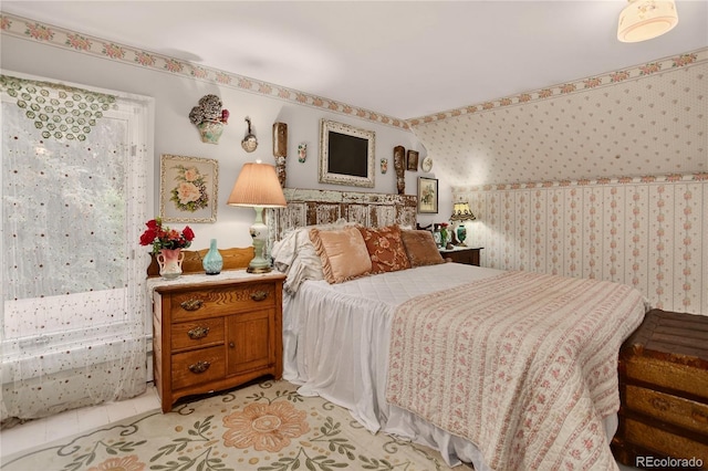 5975 Wellington Rd, Cascade, CO 80809 - bedroom with wallpapered walls and light tile patterned floors