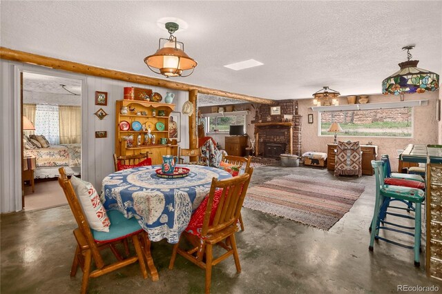 5975 Wellington Rd, Cascade, CO 80809 - dining space featuring concrete floors and a textured ceiling