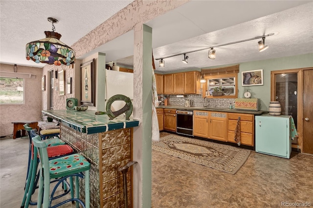 5975 Wellington Rd, Cascade, CO 80809 - kitchen featuring black dishwasher, a textured ceiling, and tasteful backsplash