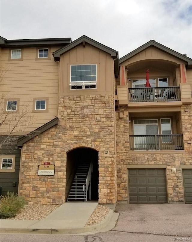 view of building exterior with driveway and an attached garage