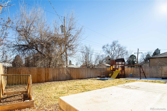 view of yard with a playground and a patio