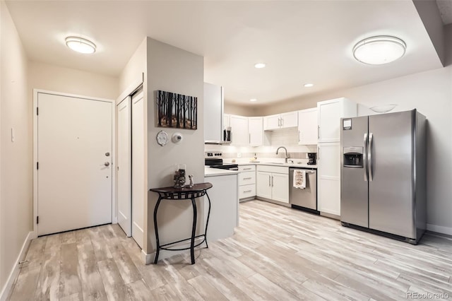 3144 S Wheeling Way Unit 401, Aurora, CO 80014 - kitchen featuring stainless steel appliances, a sink, white cabinetry, light wood-style flooring, and recessed lighting