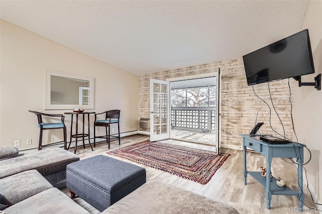 3144 S Wheeling Way Unit 401, Aurora, CO 80014 - living room featuring baseboard heating, wood finished floors, a textured ceiling, baseboards, and wooden walls