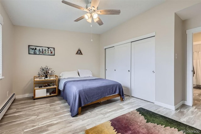 3144 S Wheeling Way Unit 401, Aurora, CO 80014 - bedroom with a baseboard heating unit, light wood-type flooring, a closet, baseboards, and a ceiling fan
