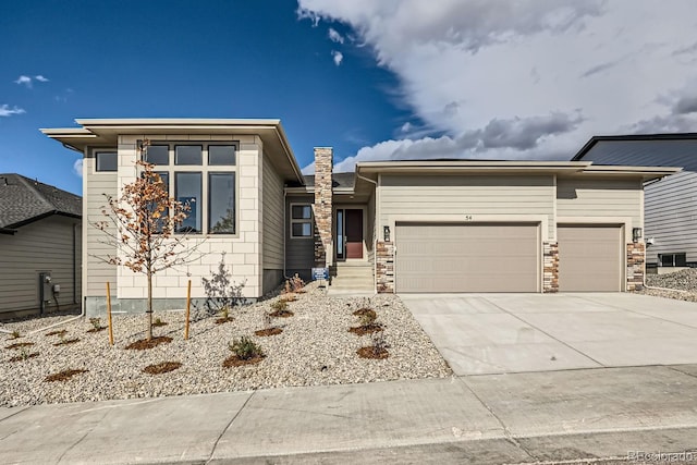 prairie-style home featuring a garage and concrete driveway