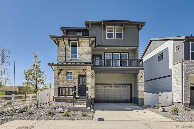 2190 S Haleyville Way, Aurora, CO 80018 - view of front of house with a balcony, stone siding, driveway, and an attached garage