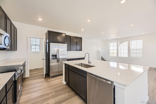 2190 S Haleyville Way, Aurora, CO 80018 - kitchen featuring stainless steel appliances, a sink, light wood-type flooring, recessed lighting, and light stone counters