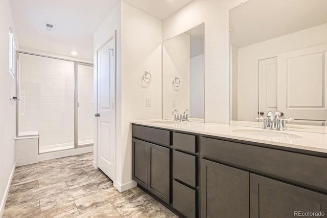 2190 S Haleyville Way, Aurora, CO 80018 - full bathroom with double vanity, a shower stall, baseboards, and recessed lighting