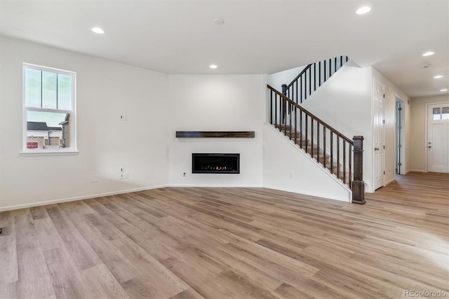 unfurnished living room with light wood-type flooring