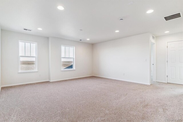 unfurnished room with light colored carpet